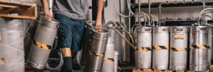 Man carrying kegs at the Garage